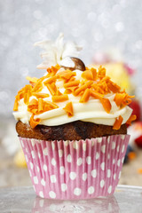 Carnival muffin decorated with orange sprinkles