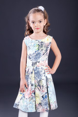 Portrait of little girl in luxurious dress. Fashion photo