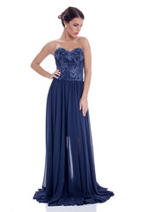 elegant young woman in long dark blue dress,isolated on white