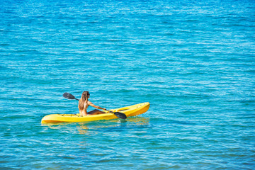 Woman Kayaking in the Ocean on Vacation