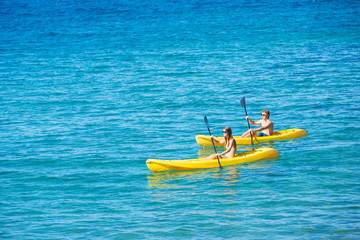 Man and Woman Kayaking in the Ocean