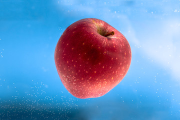 Small apple in see trough water