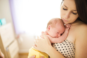 Happy mother with baby at home