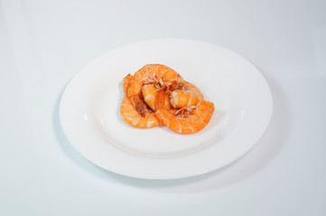 Boiled red prawns on a white plate