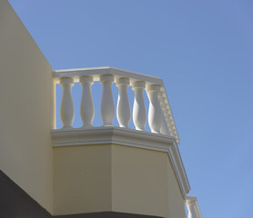 White concrete balustrade on blue sky background.
