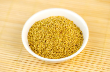 Flaxseed meal powder in white bowl