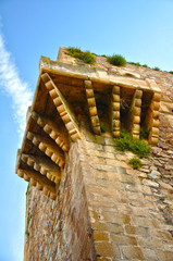 Historic centre of Caceres: cantilevered structure at the top of a fortified tower, to observe and...