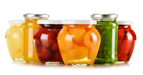 Jars with fruity compotes and jams isolated on white