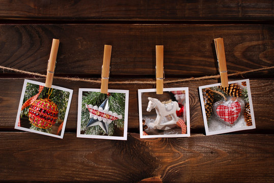 christmas photos hanging on rope against wooden background