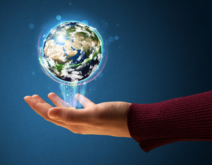 Woman holding a glowing earth globe