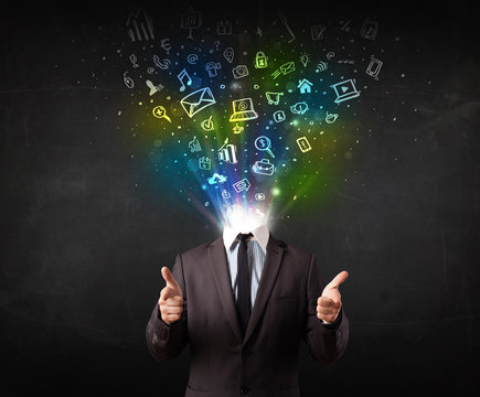 Business man with glowing media icons exploding head