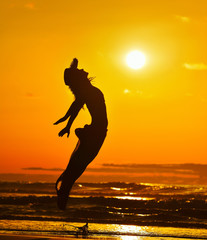 young woman on the beach in summer sunset light