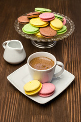 Colorful macaroons and cup with coffee