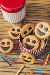 Round smiling chocolate cookies with colourful confetti