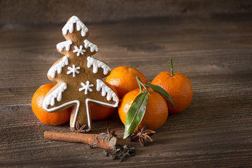 Gingerbread and orange on wooden background