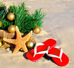 Christmas tree with christmas balls, slippers and starfish on th