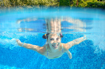 Underwater child swims in pool, girl swimming, kids sport