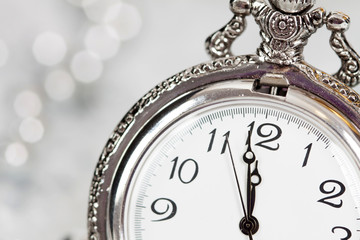 Obraz na płótnie Canvas Old silver clock close to midnight and Christmas decorations