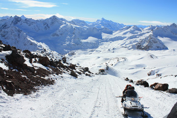 Snowmobile in the high snowy mountains