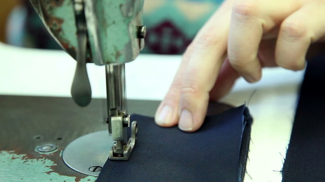 woman sews clothes in a sewing workshop, close up 3