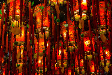 Closeup of many lit red lamps/lanterns in a temple