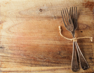 two fork tied by string on old wood, background