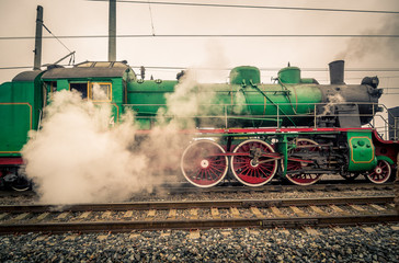 Old steam engine locomotive is preparing to start movement