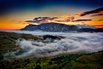 beautiful mountain landscape in foggy morning in Romania