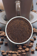 Closeup a stovetop coffee maker filter, with ground coffee.