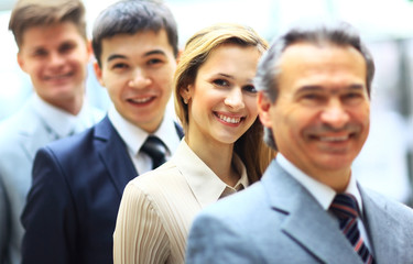 Happy smiling business team standing in a row