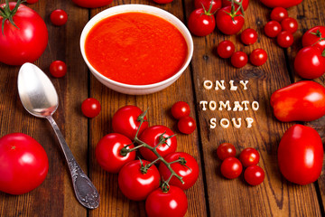 Tomatoes soup on a wooden table