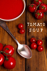 Tomatoes soup on a wooden table
