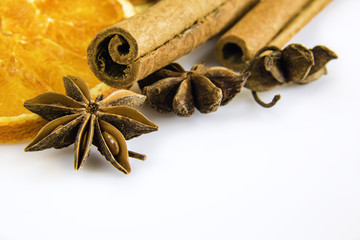 some anise stars and cassia cinnamon with dried orange rings