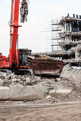 Fototapeta na wymiar Building demolition by machinery for new construction.