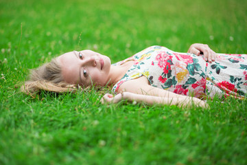 Young girl lying on the grass on a summer day