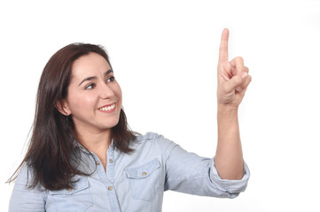 happy Hispanic woman pointing with finger on blank copy space