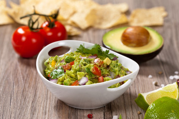 Guacamole with avocado, lime, tomato and cilantro