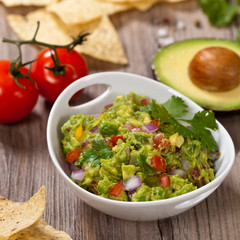 Guacamole with avocado, lime, tomato and cilantro