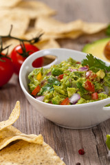 Guacamole with avocado, lime, tomato and cilantro