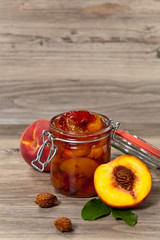 Peach or Nectarine Jam on wooden background. Selective focus.
