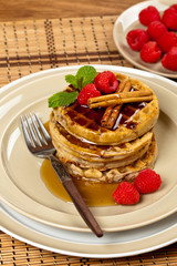 Waffles with raspberries and cinnamon. Selective focus.