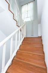 wooden staircase made from laminate wood in white modern house