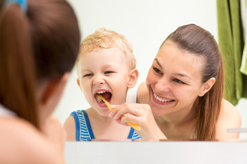 mother teaching kid teeth brushing