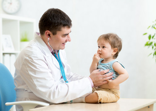 pediatrician examining heartbeat of baby with stethoscope