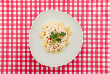 Gnocchi plate on Red and white checkered table