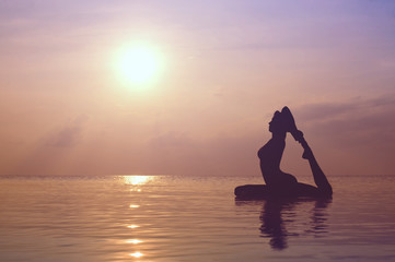Silhouette young woman practicing yoga