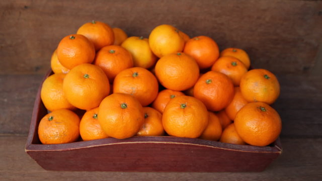 Oranges in wooden tray.