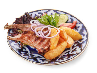 Meat on a grill with vegetables