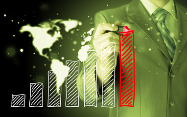 Business man drawing a growing graph