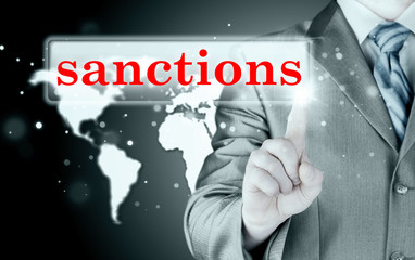 businessman pressing sanctions button on virtual screens